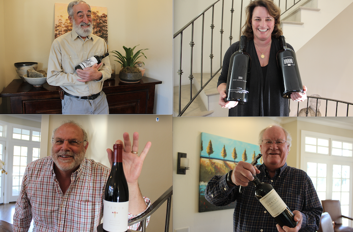 People holding wine bottles indoors.